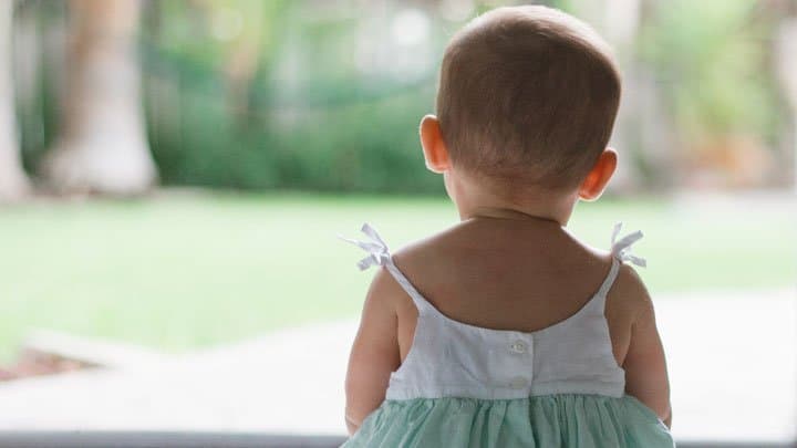 girl baby looking out the window