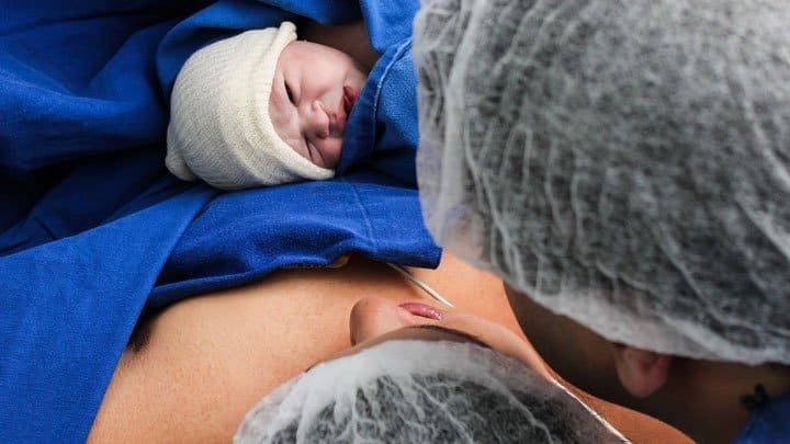 infant lying on mothers belly
