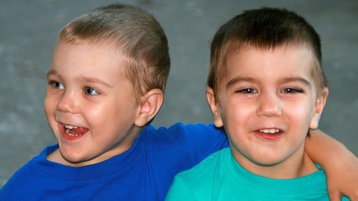 Brothers standing beside each other