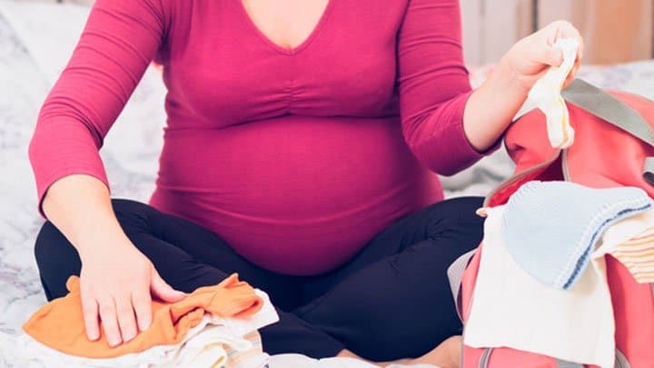 woman packing hospital bag for twins