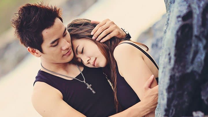 Man holding woman in his arms