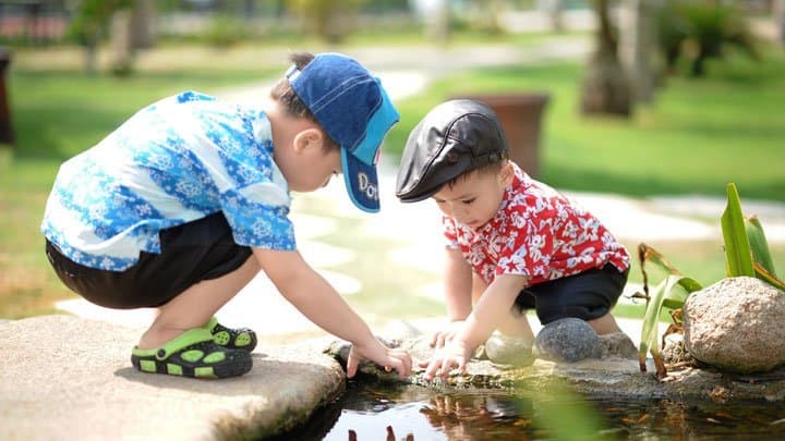 Twin brothers playing with water