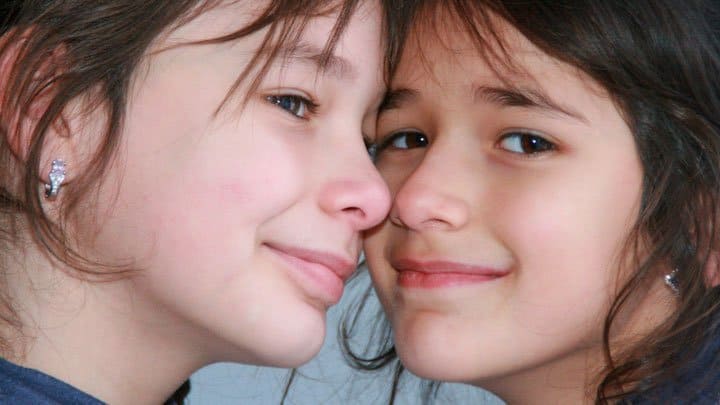 Twin sisters smiling