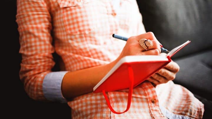 Woman writing in diary